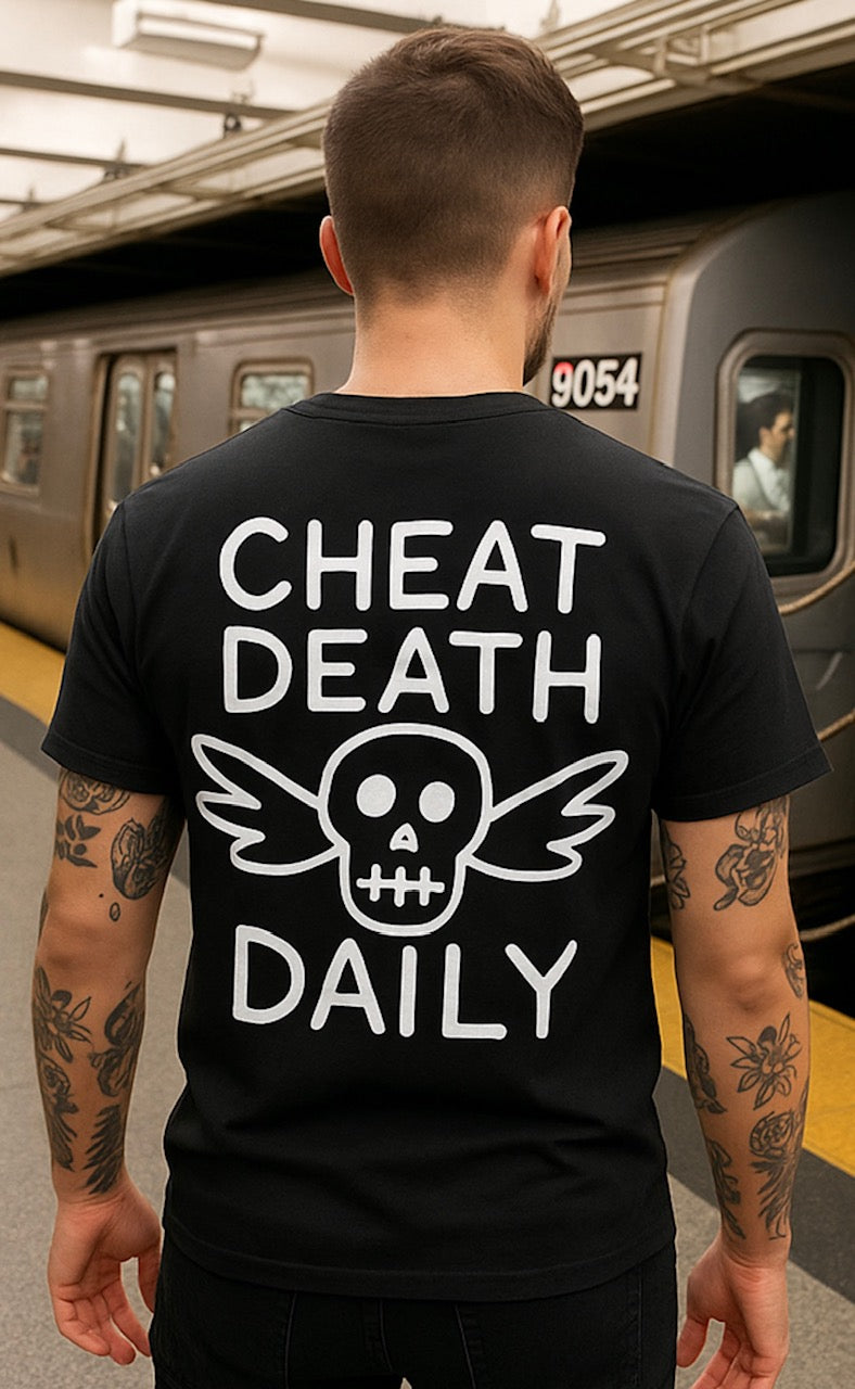 The "Cheat Death" Tee by Highway Division says everything without saying too much. Featuring bold "Cheat Death" lettering on both the front and back, this all-black staple is made for those who live fast, ride hard, and never look over their shoulder.

Crafted from heavyweight cotton with a relaxed fit, it’s built for the long haul — whether you're skating pavement, twisting throttle, or just moving through the world on your own terms.

Details:

Color: Black

“Cheat Death” text screen printed on front and 