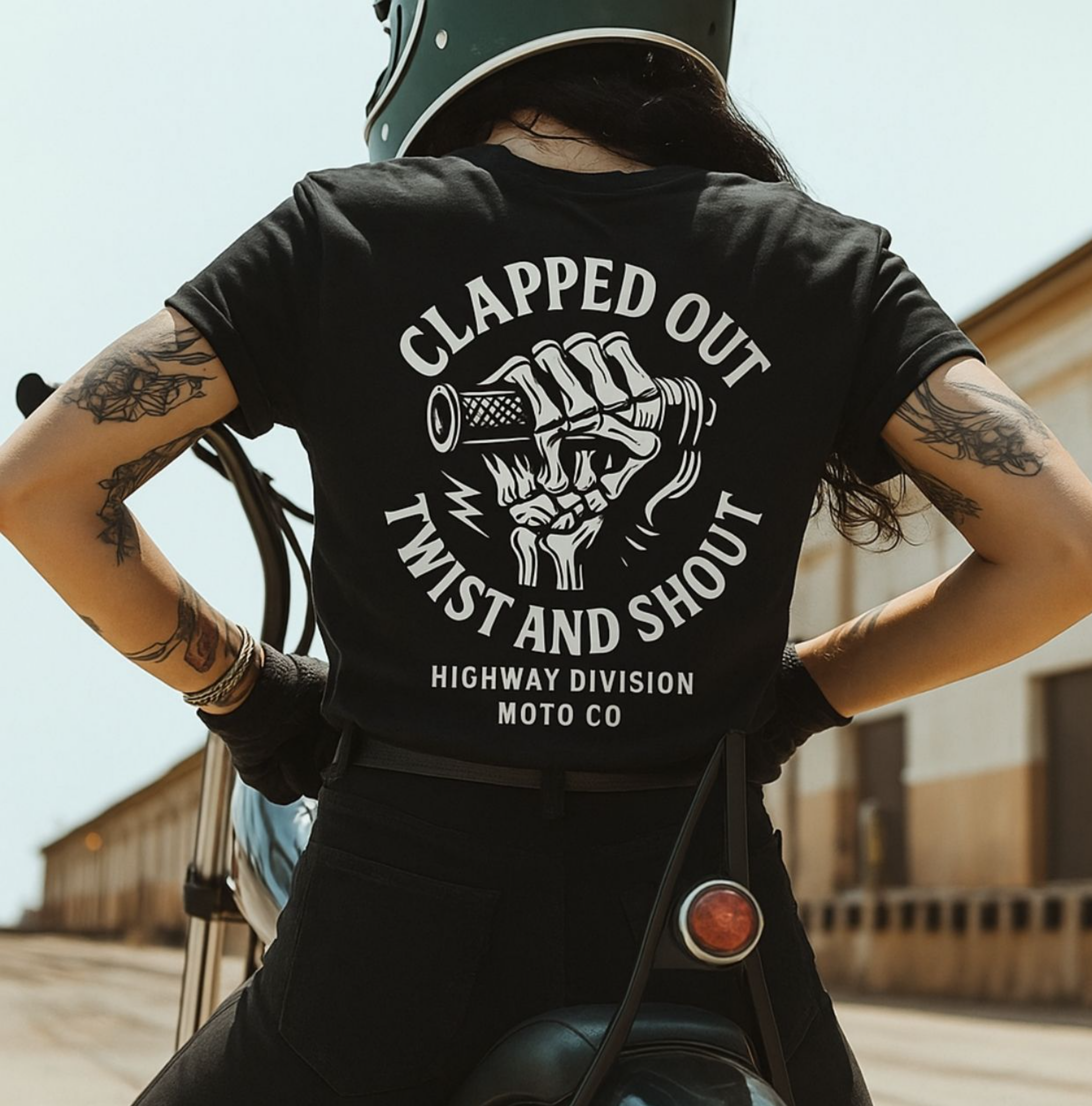 Black t-shirt by Highway Division with bold “CLAPPED OUT TWIST AND SHOUT” print; soft cotton motorcycle streetwear for riders, mechanics, and garage-built culture.
