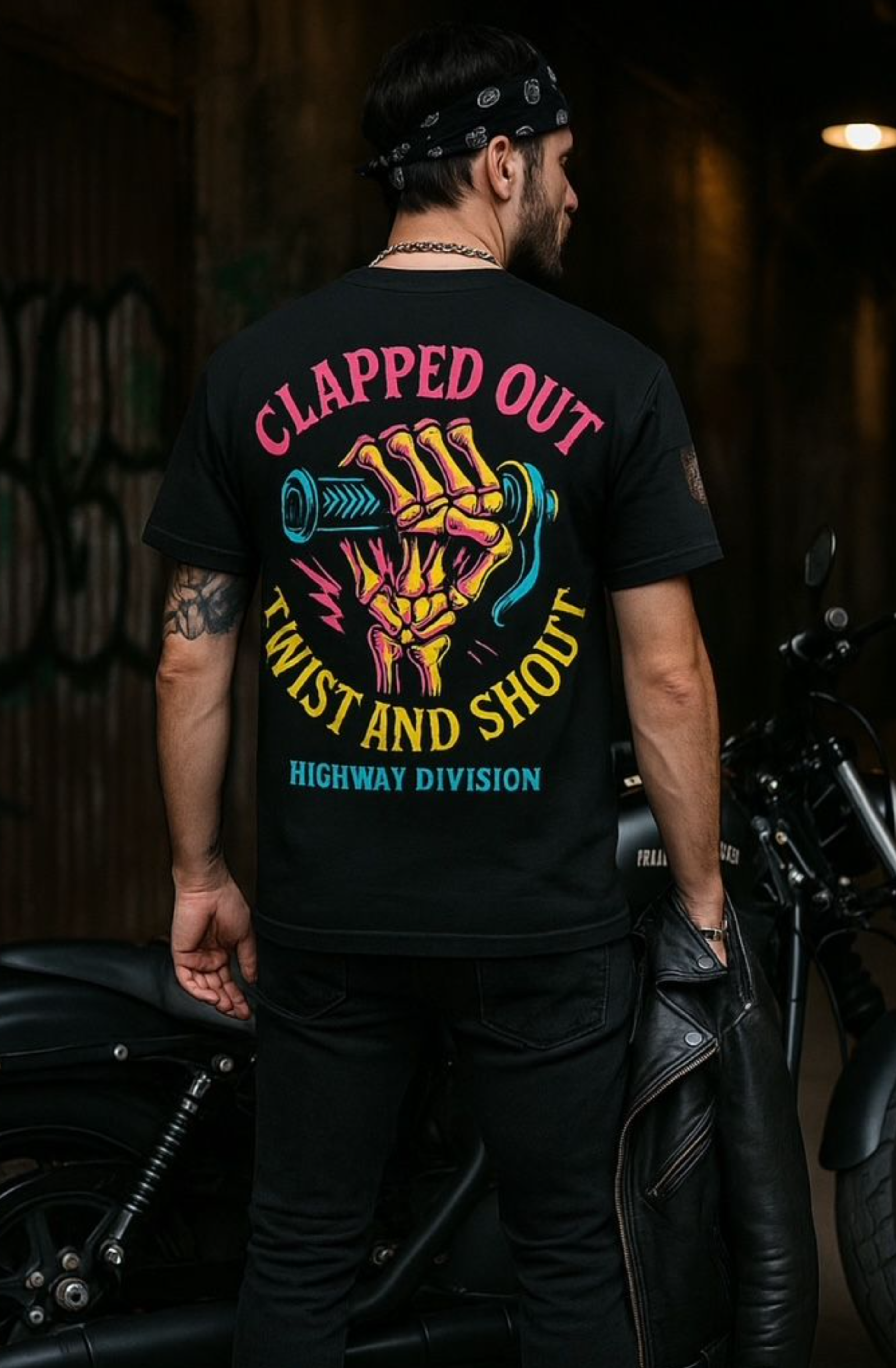 Highway Division 'Clapped Out Twist and Shout' T-shirt featuring bold, retro-inspired lettering with a distressed finish. The design channels greasy garage vibes and worn-out horsepower, reflecting vintage motorcycle culture and the raw spirit of the Harley-Davidson lifestyle