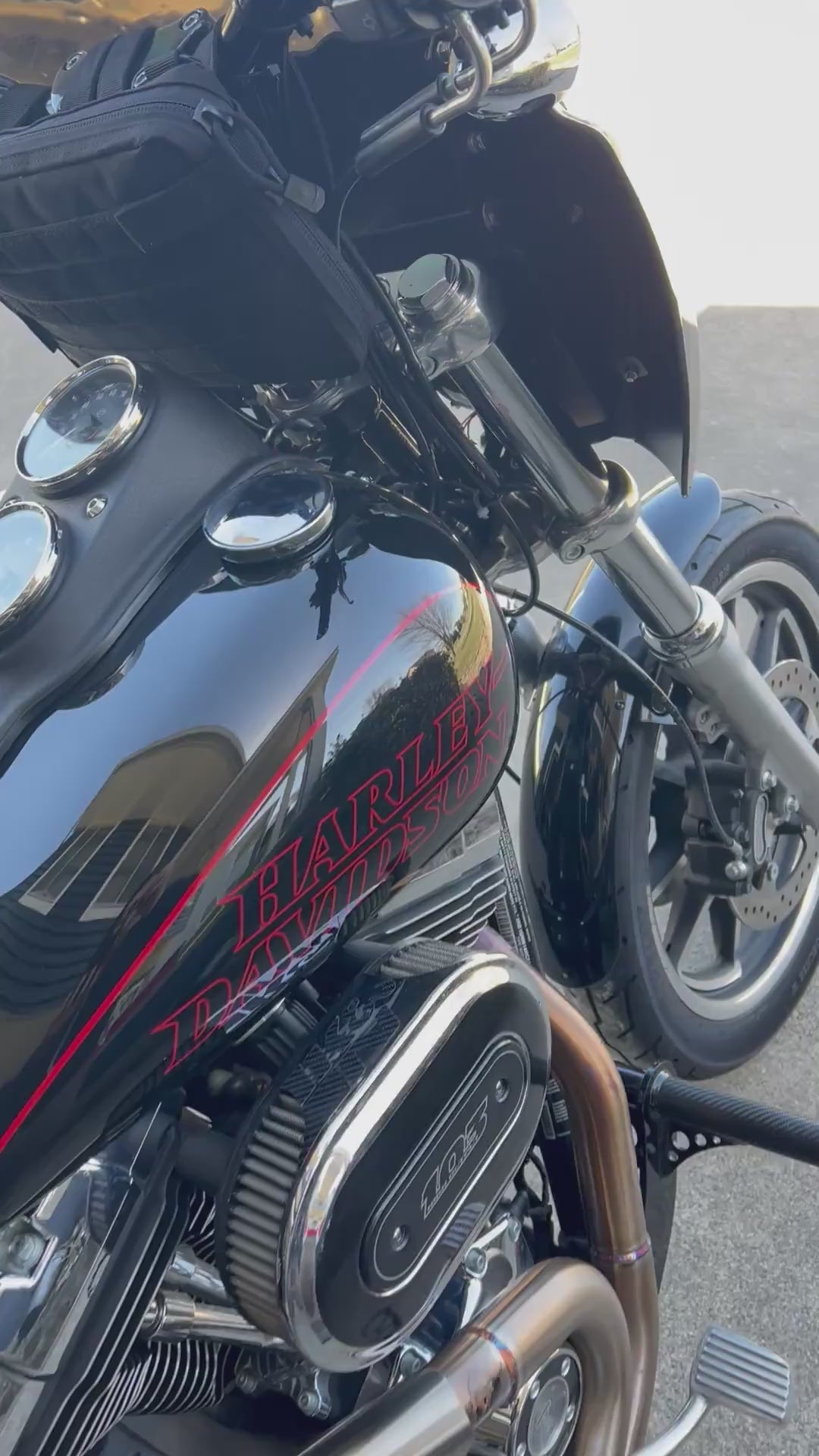 2017 Harley-Davidson Dyna Low Rider cruising on the road, rider wearing Highway Division apparel